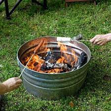 Easy Diy Fire Pit Genius I Think I Would Prop It Up On 3 Bricks To Keep It Off The Ground What I Backyard Campout Fire Pit Backyard Backyard Campout Party
