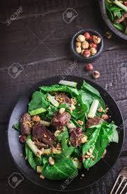 In a large bowl, toss the spinach with all but 2 tablespoons of the dressing. Green Salad With Liver And Spinach On Dark Rustic Background Selective Stock Photo Picture And Royalty Free Image Image 95008417