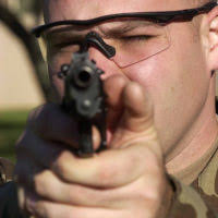 AIRMAN First Class (A1C) Christopher J. Gunderman, USAF, 568th Security  Forces Squadron (SFS), guards the west gate at Ramstein Air Base, Germany,  armed with a Colt 5.56 mm M16A2 rifle