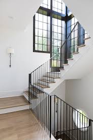 Metal Railing Spindles Staircase The Stunning Staircase Features Custom Iron Railings Hardwood Threads And Black English Farmhouse Staircase Design Staircase