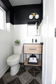 In a small powder room without much access to natural light—for example, a windowless space under the stairs—embrace the moodier, edgier atmosphere with darker tones and dim lighting. Black White Powder Room Makeover Small Bathroom Makeover Powder Room Small Bathroom Makeover