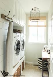 The countertop makes a great place for folding and storing, and the door provides a little natural light to motivate you to finish that last load of laundry. Laundry Room Farmhouse Light The Wood Grain Cottage