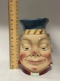 What is the design and era of this 18" tall jug?