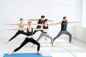 1 top 10 beginner yoga dvd recommendations. Five Young Men And Women Practicing Yoga In Warrior Ii Pose Free Stock Photo And Image