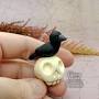 Profile Picture of Mini Polymer Clay Crow Sitting on a Skull | The Lurking Quirk (@thelurkingquirk.com) on Google