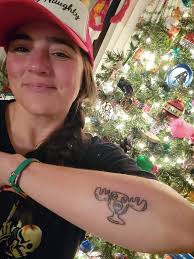 Not sure if allowed.. but got this tattoo with my grandsons names .. and  now have a third grandson Kyrie. Anyone able to sketch another name and  flower