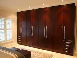 Example of a large classic master medium tone wood floor, brown floor and wall paneling bedroom design in nashville with white walls, a standard fireplace and a stone fireplace. Designs For Bedrooms Pictures Woodwork Decor And Design Master Bedroom Photos Cupboard Design Bedroom Cupboard Designs Wall Cupboard Designs