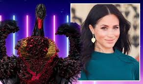 The black swan wears a short black dress, covered in black feathers. The Masked Singer Swan S Identity Exposed As Meghan Markle After Huge Royal Clue Tv Radio Showbiz Tv Express Co Uk