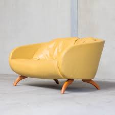 Modern home living room interior involving gray sectional sofa designed with tufted detail and yellow pillows. Yellow Leather Sofa By Sitting Vision The Netherlands 80819