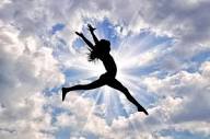 Concept of happiness and freedom. silhouette of happy girl jumping on a  background of a beautiful sunny sky | Premium Photo