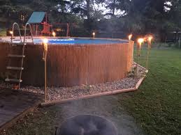 Reed Privacy Fence Added Around Our Above Ground Pool Accented With Tiki Torc Backyard Pool Landscaping Above Ground Pool Landscaping Swimming Pool Landscaping