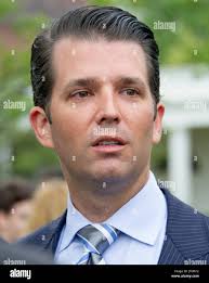 In this Monday, April 3, 2017 photo, Oklahoma Highway Patrol Trooper Dwight  Durant poses for a photo in his car in Oklahoma City. Four years ago,  Oklahoma's oil patch was booming, and