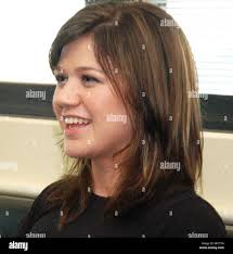 Bob Stoops, left, former Oklahoma head coach, looks up at the scoreboard  with his wife, Carol, right, in the fourth quarter of an NCAA college  football game against West Virginia in Norman,