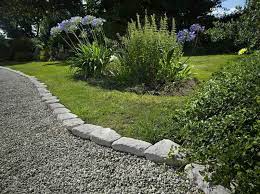This garden looks well manicured, and elaborately designed, but if you look closely you will find that this is the effect of only two things: Limestone Border And Gravel Path Garden Edging Backyard Garden Landscape Landscaping With Rocks