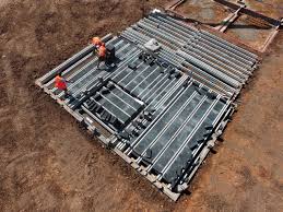 A bolt is run through a plate that is welded to the bottom of the beams and down into holes in the concrete. Beam Block Concrete Floors Precast Supply Install Essex Milbank