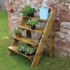 I think you could build a reasonably tall ladder using a similar layout, but you would want to angle the legs outwards, and then you would need to use something other than dado joints for the steps. Wooden Garden Plant Ladder By Grange Internet Gardener Wooden Garden Planters Garden Plant Pots Garden Ladder