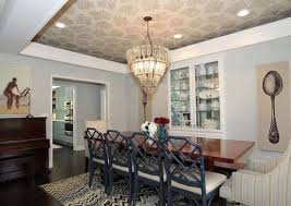 The higher center of the ceiling also gives a chance to make a focal point by installing a lovely chandelier, ceiling fan, or pendant light. 12 Photos That Prove Wallpaper Still Wows Painted Tray Ceilings Dining Room Walls Dining Room Ceiling