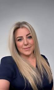 Can someone edit this photo to change the scrub top and background for a  clinic picture?