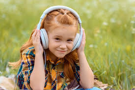 The best gifs for listening to music. Portrait Of Smiling Kid Listening Music In Headphones With Green Grass On Background Free Stock Photo And Image