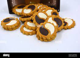 Delicious sandy sweet cookies with sharp edges and chocolate and white  filler invested in brown brown packaging Stock Photo - Alamy