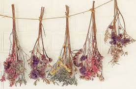 Using white or clear thread, hang flowers from small command hooks or tacks. Mcnamara Florist Mcnamara Florist