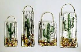 First you put some stones on the bottom of your then add the turf but make sure to push it to the side (walls) so you can plant your cactus in the middle. Vases Latta S Fused Glass