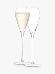 The flute is the most common glass shape for champagne; Champagne Flutes Saucers John Lewis Partners