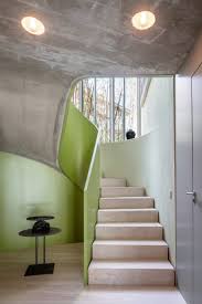 One Of The Tall Voids Contains The Staircase Which Features A Sweeping Green Balustrade An Contemporary Fireplace Contemporary House Interior Design Your Home