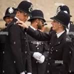 New Metropolitan Police officers check their uniforms before ...