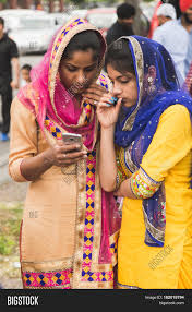 Usually, the traditional dress for sikh men has been european style trouser and shirt whereas sikh women put salwar kamij. Sikh Women Taking Part Image Photo Free Trial Bigstock