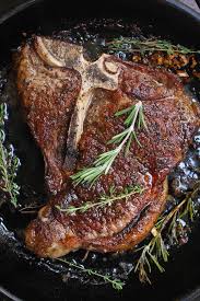 Pan Seared T Bone Steak In A Cast Iron Pan Showing A Beautiful Golden Crust With Sprigs Of Fresh Rose Cooking T Bone Steak Tbone Steak Recipe Steak Recipes Pan