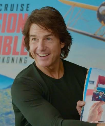here's tom cruise holding photos of tom cruise which are photos that i have taken of tom cruise i haven't shared these clips yet but i was just looking at these photos