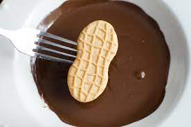 Dip both ends of each nutter butter cookies in white chocolate, leaving some candy showing in the center (for santa's face). Nutter Butter Football Cookies A Grande Life