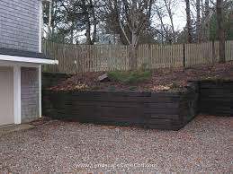 The ties are held to the ground and each other with spikes of rebar. Old Railroad Tie Retaining Walls Railroad Tie Retaining Wall Landscaping Retaining Walls Retaining Wall