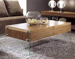 The tempered glass top floats above the boomerang shaped legs. Contemporary Floating Coffee Table With Glass Legs Center Table Decor Living Room Coffee Table Coffee Table
