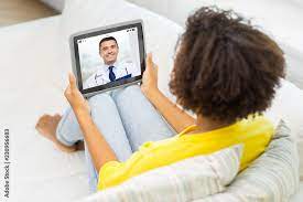 medicine, technology and healthcare concept - african american young woman  or patient having video chat with doctor on tablet pc computer at home  фотография Stock | Adobe Stock