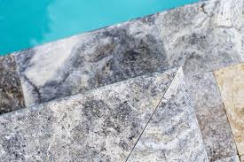 Pool coping is the material that surrounds the edge of the pool, often with a small overhang. Silver Travertine Pool Coping Silver Travertine Pool Deck