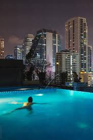 This pool is for guests only and sits on top of the marina bay sands hotel 57 stories above ground. Man In A Swimming Pool On The Rooftop Of A Skyscraper By Mauro Grigollo Hotel Swimming Pool