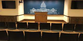 Press conference room includes podium, chairs, multiple power outlets, mult box, and video connections. Press Conference Room B971 At State Of Minnesota