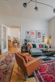 Mid Century Boho Living Room With Oriental Rugs And Large Gallery Wall Rugs In Living Room Mid Century Living Room Cozy Living Rooms