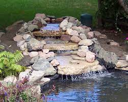 Desugn udeas if adding a pond wto an existing pond. We Know That A Backyard Pond With Running Water Floating Plants And Darting Fish Can Make A Bland Space Br Waterfalls Backyard Ponds Backyard Pond Landscaping
