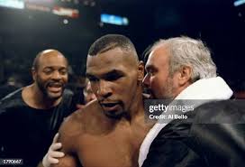 Mike Tyson is congratulated by his trainer Jay Bright after his... News  Photo