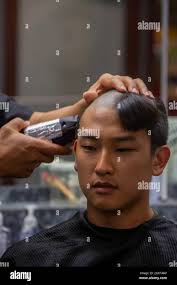 U.S. Marine Corps officer candidates from Alpha and Delta Company, receive  their initial haircuts during Officer Candidates School (OCS), at Marine  Corps Base Quantico, Va., June 26, 2021. Candidates receive routine haircuts