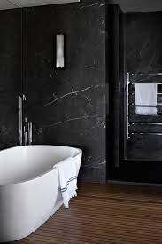 This 18×18 polished calacatta gold marble floor tile. House Tour Relaxed Refinement On Sydney Harbour Black Marble Bathroom Marble Bathroom Designs Dark Interior Design