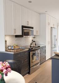 White upper cabinets dark lower cabinets design photos ideas and inspiration. Bi Colour Kitchen Cabinets Stainless Steel Counter Top And Subway Tiles Kitchen Inspirations Home Kitchens Kitchen Design