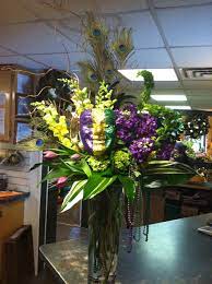 Creating a mardi gras centerpiece can be fun and simple. Mardi Gras Floral Arrangement Mardi Gras Centerpieces Mardi Gras Wedding Theme Mardi Gras Decorations