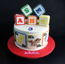 These pastel rainbow cake decorations will sure have your toddler mumbling abc! Abc Blocks Cake Baby Birthday Cakes Alphabet Cake 1 Year Old Birthday Cake