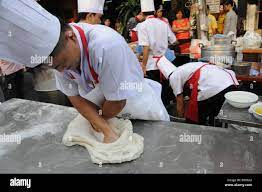 Chinese Coock makes fresh Noodel Dough Stock Photo - Alamy