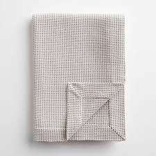 Perfect for bed, sofa or couch, this woven knit blanket is made of merino wool. Dobby Gray And Ivory Throw Blanket Unison