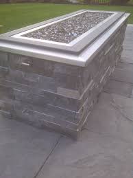 Raised Gas Fire Pit With Crushed Glass Stone Cladding And Stainless Steel Cap Glass Fire Pit Outdoor Fire Pit Gas Firepit